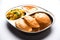 Aloo Fry OR Bombay potatoes and puri/Poori in a stainless steel oval plate