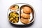 Aloo Fry OR Bombay potatoes and puri/Poori in a stainless steel oval plate