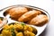 Aloo Fry OR Bombay potatoes and puri/Poori in a stainless steel oval plate