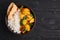 Aloo gobi with rice and chapati. Indian cuisine vegetarian curry at black wooden background
