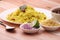 Aloo/Kanda Poha or Tarri Pohe with spicy chana masala/curry. Served in ceramic plate.