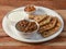 Aloo Paratha or Indian Potato stuffed Flatbread and channa masala Served with fresh curd and pickle. isolated over a rustic wooden