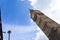 ALow angle view of the Big Ben in London England United Kingdom against a blue sky with white clouds and a Union Jack British flag