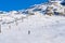 Alpe D'Huez, France - 31.12.2021: Skiers skiing, chairlifts in Alpine ski resort on bright winter day. Winter