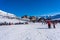 Alpe D\'Huez, France - 31.12.2021: Skiers skiing, chairlifts in Alpine ski resort on bright winter day. Winter