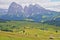 Alpe de Siusi above Ortisei with Sassolungo and Sassopiatto mountains in the background and mountain huts in the foreground, Val G