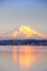 Alpenglow on Mount Rainier reflects on Puget Sound