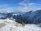 Alpes ski resort slopes, mountain panorama and sun aerial view,