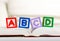 Alphabet block with ABCD on book