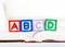 Alphabet block with ABCD on book