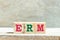 Alphabet block in word ERM Abbreviation of Enterprise risk management on wood background