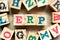 Alphabet block in word ERP abbreviation of  Enterprise Resource Planning with another on wood background