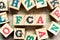 Alphabet block in word FCA Abbreviation of free carrier with another on wood background