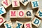 Alphabet block in word MOQ Abbreviation of Minimum Order Quantity with another on wood background