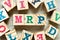 Alphabet block in word MRP Abbreviation of Material requirements planning with another on wood background