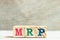 Alphabet block in word MRP Abbreviation of Material requirements planning on wood background