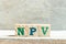 Alphabet block in word NPV Abbreviation of net present value on wood background