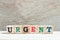 Alphabet block in word urgent on wood background