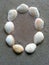 Alphabet character O created with seashells on beach-sand