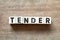 Alphabet letter block in word tender on wood background