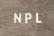 Alphabet letter in word NPL Abbbreviation of Non Performing Loan, Non-Patent Literature on wood background