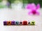 Alphabet `Saturday` beads in cube shape with blurred background ,block letters ,happy Saturday wallpaper or text ,colorful charact