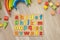 Alphabet wooden board with colored font letters in cells closeup isolated