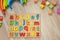 Alphabet wooden board with colored font letters in cells closeup isolated