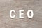 Alphabet in word CEO Abbreviation of Chief Executive Officer on wood background