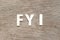 Alphabet in word FYI Abbreviation of For your information on wood background