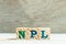 Alphabet in word NPL Abbbreviation of Non Performing Loan, Non-Patent Literature on wood background