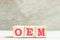 Alphabet in word OEM Abbreviation of Original Equipment Manufacturer on wood background