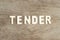 Alphabet in word tender on wood background
