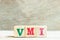 Alphabet in word VMI abbreviation of vendor managed inventory on wood background