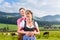 Alpine cattle farmers on mountain meadow