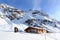 Alpine chalet house and mountain panorama with snow in winter in Stubai Alps