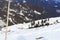 Alpine chalet houses and mountain snow panorama with trees in winter in Stubai Alps