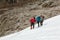 Alpine Climbers heavily stepping up on Snow Slope