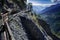 Alpine hiking trail, narrow path along the mountainside, valley and mountain background, Switzerland