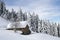 Alpine hut under snow