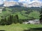 Alpine landscape with La Villa village, green pastures and firs against italian Dolomites at summer . La Villa, Bolzano