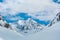 Alpine landscape with peaks covered by snow and clouds