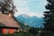 Alpine landscape scenery with distinctive wooden architectural style of mountain houses in slovenian national park Triglav
