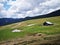 Alpine meadow in the mountains with sheepfold