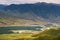 Alpine meadows with river in mountains valley