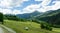 Alpine mountain landscape with farm fields and hay bales in the Swiss Alps above Andeer village