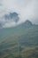 Alpine mountain pass of Splugen covered with fog, Switzerland. Vertical shot