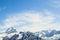 Alpine mountain peaks with blue sky and light clouds. Mountain climbing. Copy space, place for text. Motivational background.