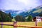 Alpine mountain with a snowy peak with a wood fence and chalets in the foreground at Talschluï¿½ in Saalbach, Austria