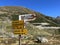 Alpine mountaineering signposts and markings in the mountainous area of the Albula Alps and above the mountain road pass Fluela